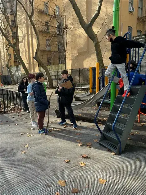 "A group of children playing on a playground with a dog, enjoying outdoor activities and fostering social interaction. "